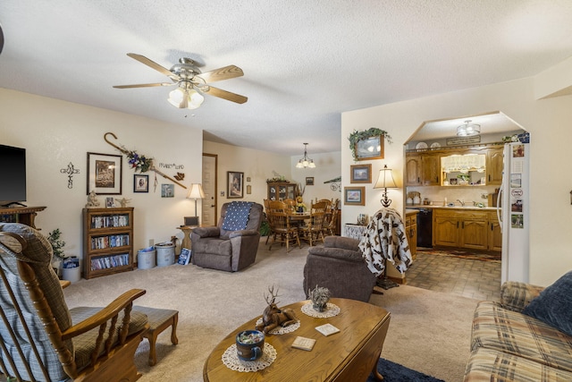 living room with light colored carpet, sink, a textured ceiling, and ceiling fan