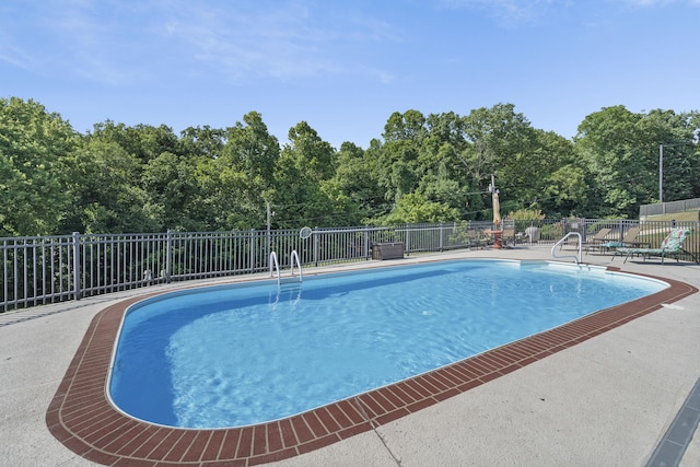 pool featuring a patio and fence