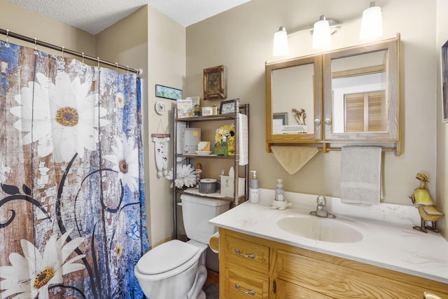 bathroom featuring toilet, vanity, a textured ceiling, and curtained shower