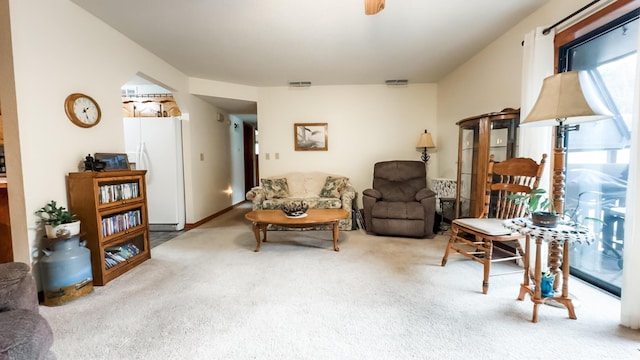 living area featuring carpet and visible vents