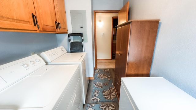 laundry area with cabinet space, washer and clothes dryer, and electric panel