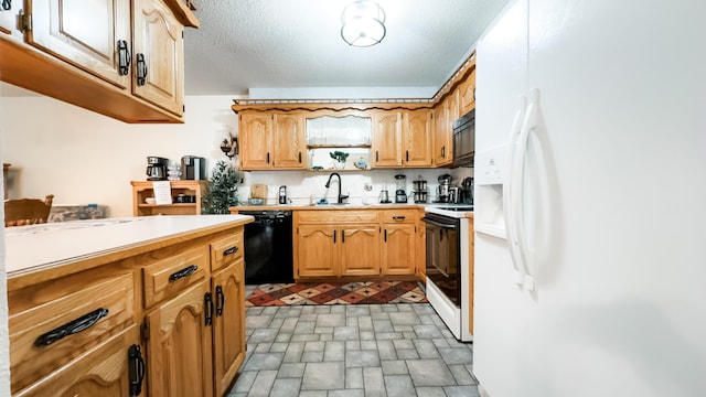 kitchen featuring light countertops, a sink, and black appliances