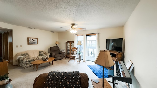 living room with carpet floors, a textured ceiling, and a ceiling fan