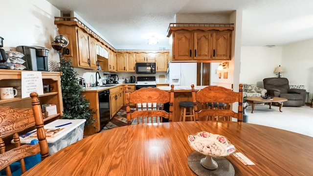 carpeted dining room with a sink