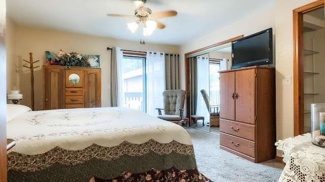 bedroom featuring multiple windows, carpet, ceiling fan, and access to outside