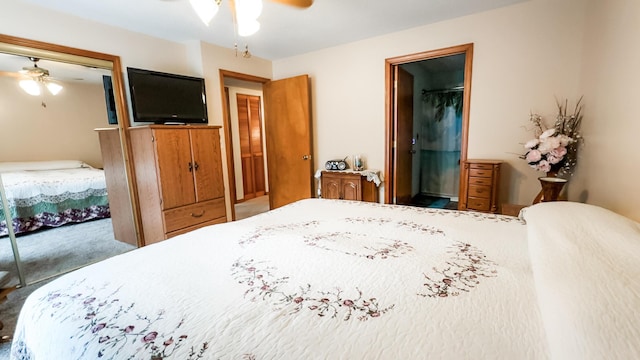 bedroom with carpet, ensuite bath, and a ceiling fan