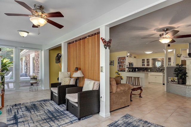 living room with light tile patterned floors and ceiling fan