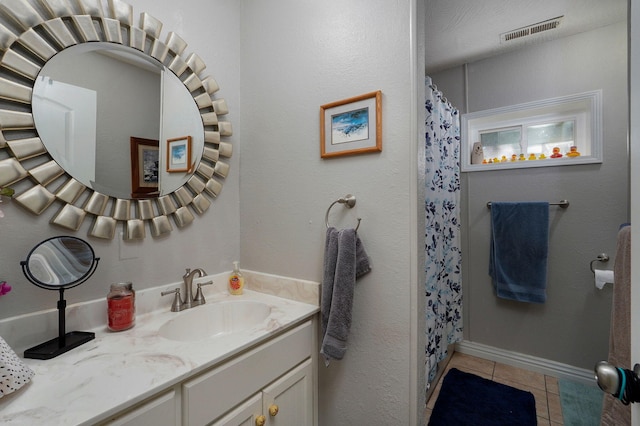 bathroom with vanity and tile patterned floors