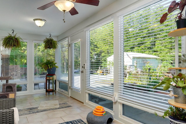 sunroom with ceiling fan and a wealth of natural light