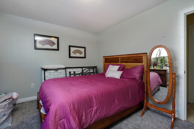 bedroom with carpet floors and a textured ceiling