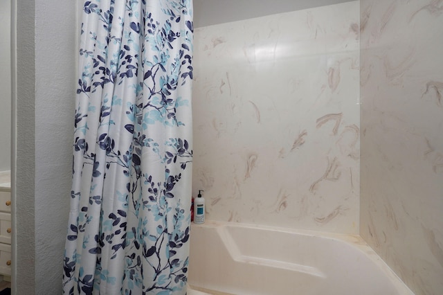 bathroom with shower / bath combination with curtain