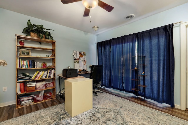 office space with dark wood-type flooring and ceiling fan