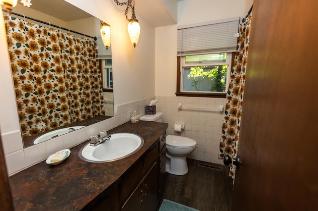 bathroom featuring vanity, tile walls, toilet, and wood-type flooring