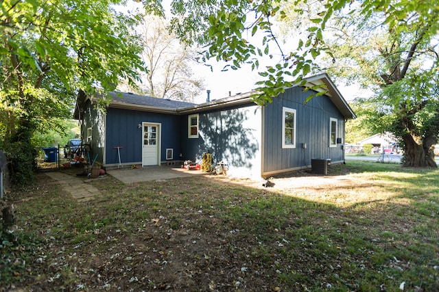 back of property featuring central air condition unit, a lawn, and a patio area