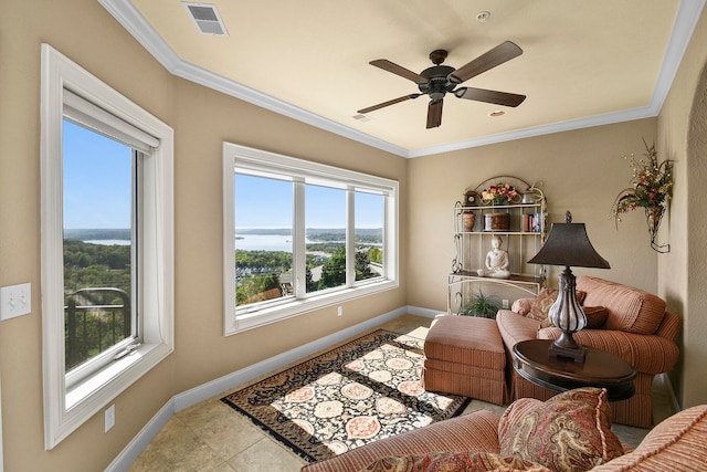 sitting room with ceiling fan, crown molding, and a wealth of natural light