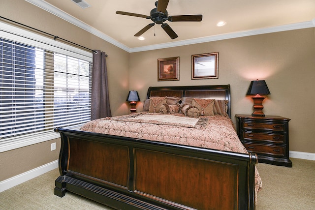 carpeted bedroom with ceiling fan and ornamental molding