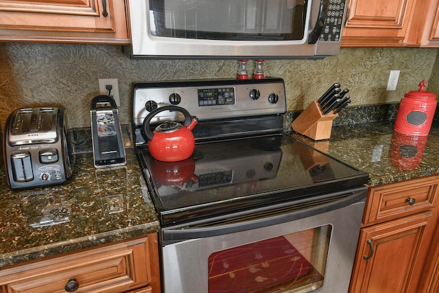 kitchen featuring appliances with stainless steel finishes and decorative backsplash