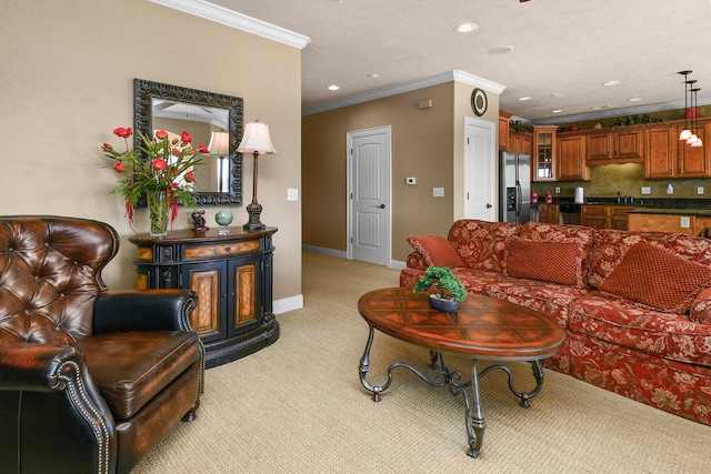 carpeted living room featuring a textured ceiling, crown molding, and sink