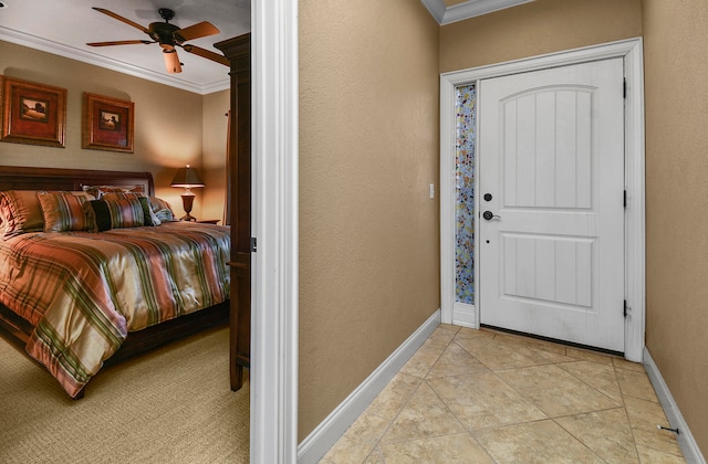 foyer with ornamental molding, light tile patterned floors, and ceiling fan