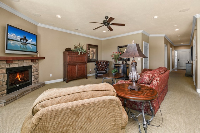 carpeted living room featuring ceiling fan, crown molding, and a stone fireplace