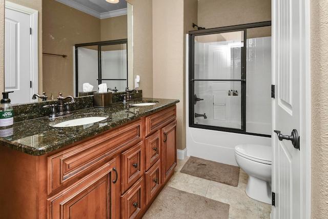 full bathroom with vanity, ornamental molding, combined bath / shower with glass door, tile patterned floors, and toilet