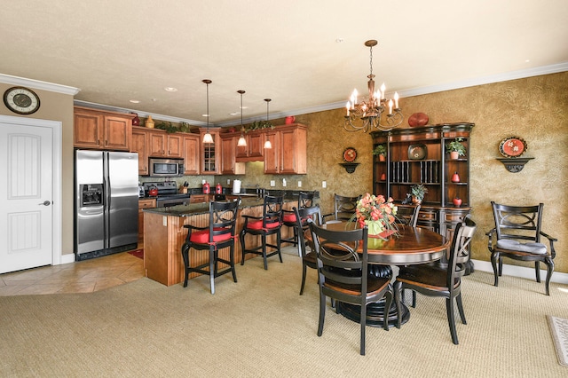 dining area with ornamental molding, a chandelier, and light tile patterned floors