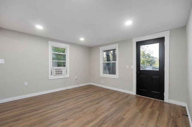 foyer with cooling unit and hardwood / wood-style flooring