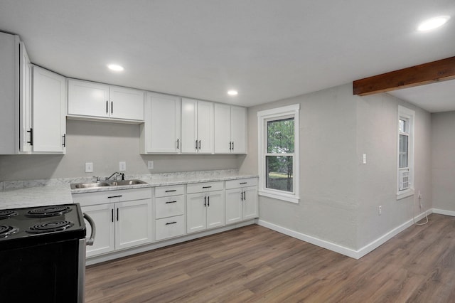 kitchen featuring black electric range, sink, dark hardwood / wood-style floors, and white cabinets