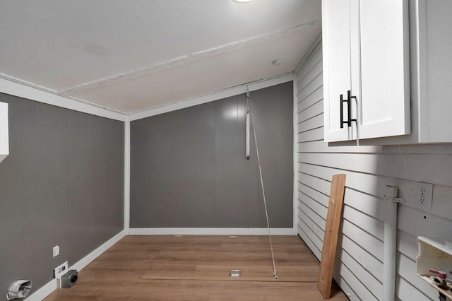 interior space featuring wooden walls and light hardwood / wood-style floors