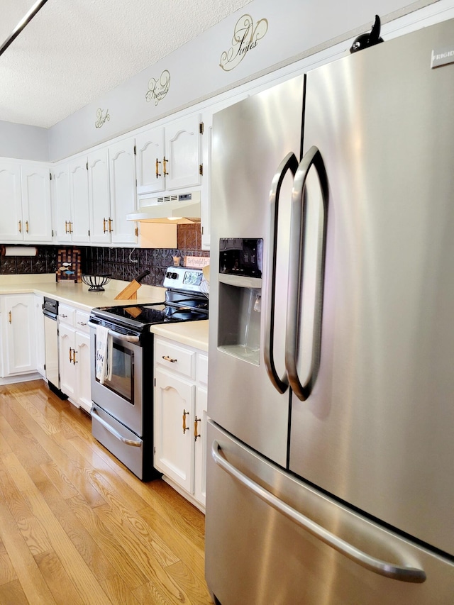 kitchen with tasteful backsplash, a textured ceiling, white cabinetry, light hardwood / wood-style floors, and stainless steel appliances