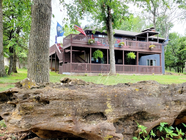 back of house featuring a wooden deck