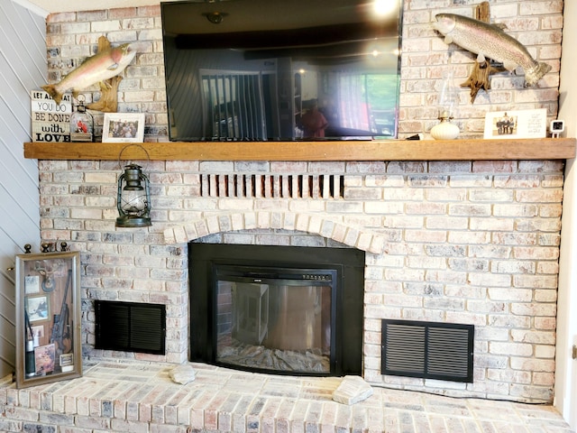 details featuring a brick fireplace