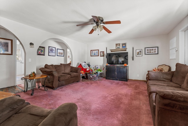 living room with ceiling fan and carpet