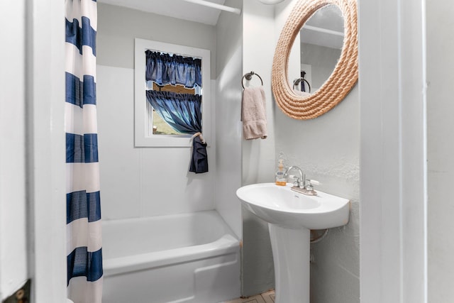 bathroom with shower / bath combo with shower curtain