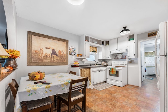 kitchen featuring white cabinets, sink, white appliances, and a wealth of natural light