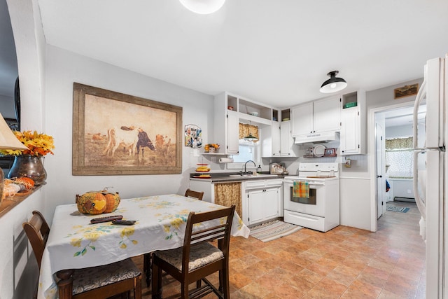 kitchen featuring white cabinets, a sink, under cabinet range hood, and white appliances