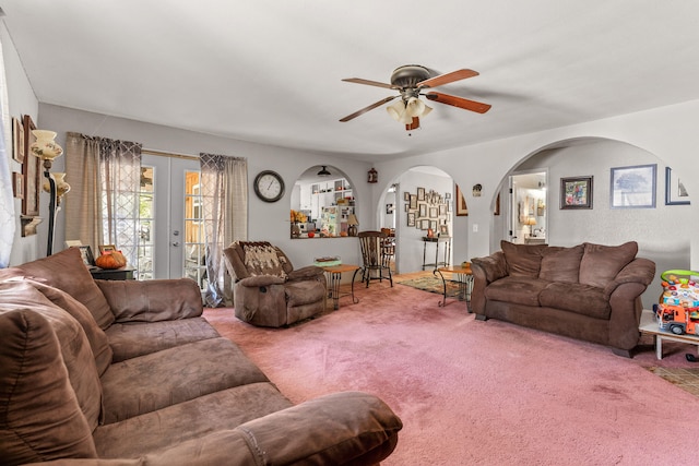 living room with french doors, carpet, and ceiling fan