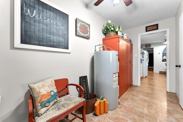 interior space featuring water heater and a textured ceiling