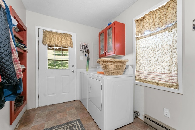 clothes washing area featuring cabinets, washer and dryer, a baseboard heating unit, and a textured ceiling