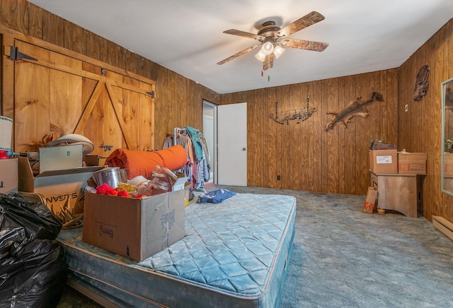 bedroom featuring ceiling fan, wood walls, and carpet flooring