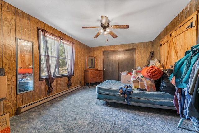bedroom featuring a baseboard radiator, wooden walls, carpet floors, and a ceiling fan