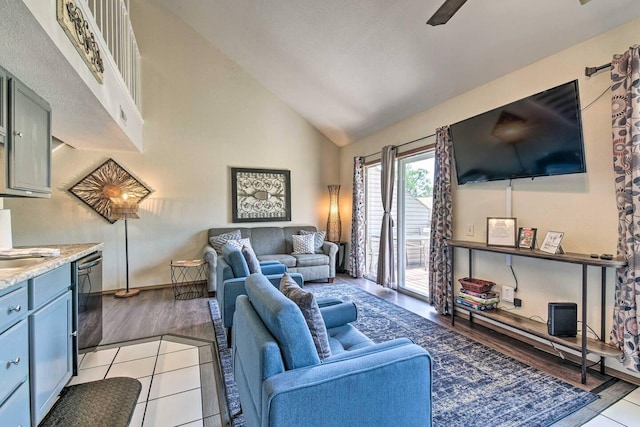 living room featuring vaulted ceiling and light tile patterned floors