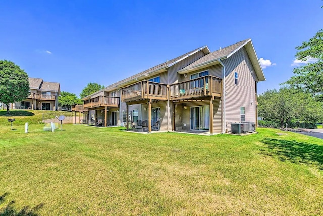 back of property with a lawn, a deck, and central AC unit