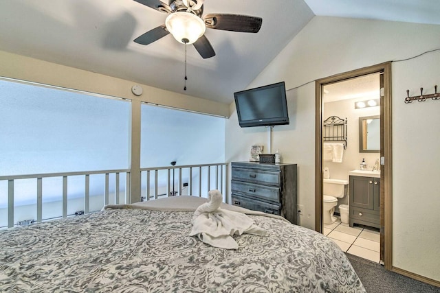 carpeted bedroom featuring lofted ceiling, ensuite bathroom, and ceiling fan