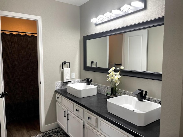 29 Fall Creek Dr Unit 4, Branson, MO 65616 - bathroom with double vanity, a textured wall, and wood finished floors
