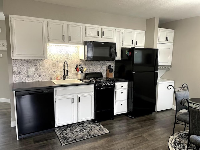 29 Fall Creek Dr Unit 4, Branson, MO 65616 - kitchen with black appliances, stacked washer / drying machine, dark wood-type flooring, backsplash, and white cabinets