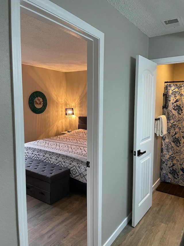 16 Fall Creek Trl Unit 2, Branson, MO 65616 - bedroom with wood finished floors and a textured ceiling