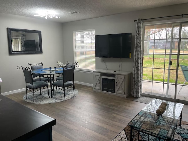 16 Fall Creek Trl Unit 2, Branson, MO 65616 - dining space featuring wood finished floors, a textured ceiling, and a fireplace