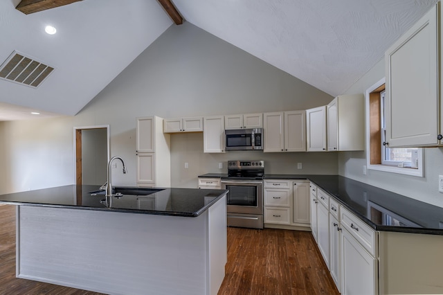 kitchen with beamed ceiling, sink, white cabinetry, stainless steel appliances, and dark hardwood / wood-style flooring