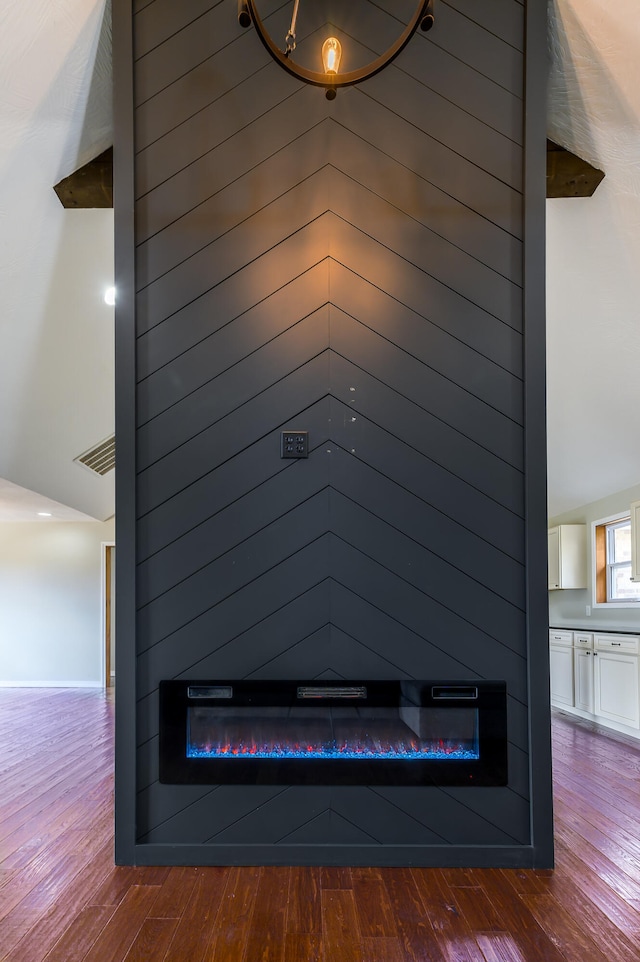 details featuring wood-type flooring, a fireplace, and wood walls